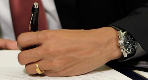President Barack Obama signs and executive order, Thursday, Jan. 22, 2009, in the Oval Office of the White House in Washington, one of which would close the prison at Guantanamo Bay. (AP Photo/Charles Dharapak)